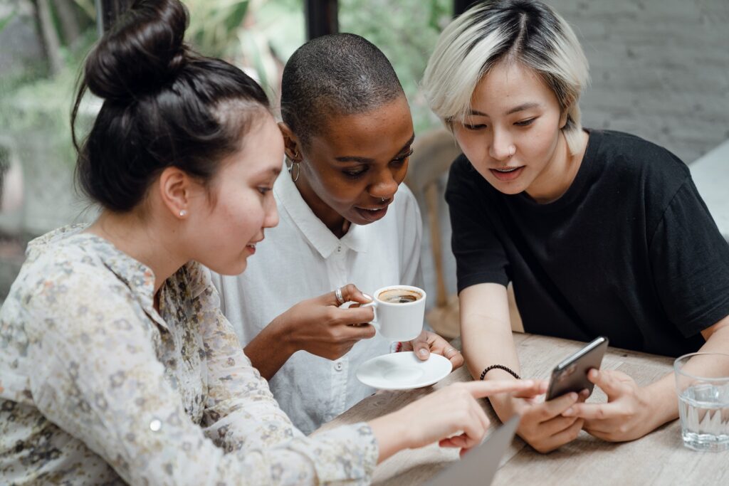 group of friends looking at a phone - Photo by Startup Stock Photos from Pexels