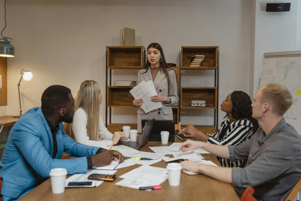 Group of 5 people in an office meeting